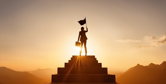 Silhouette businesswoman holding flag and rise it up standing on top of stair against mountain range view. concept of woman power, business success, leadership, target goal achieve, winner